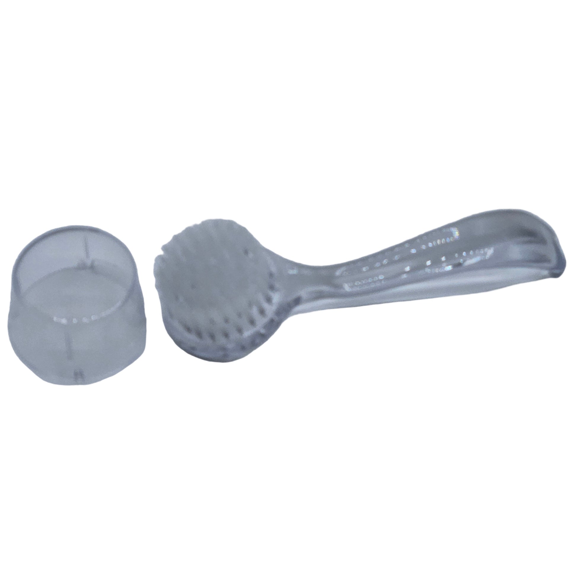 Clear plastic facial brush with a protective cover